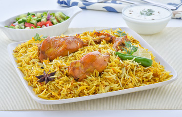 Chicken Biryani, a yummy & fluffy rice dish with spicy savory chicken pieces with salad.