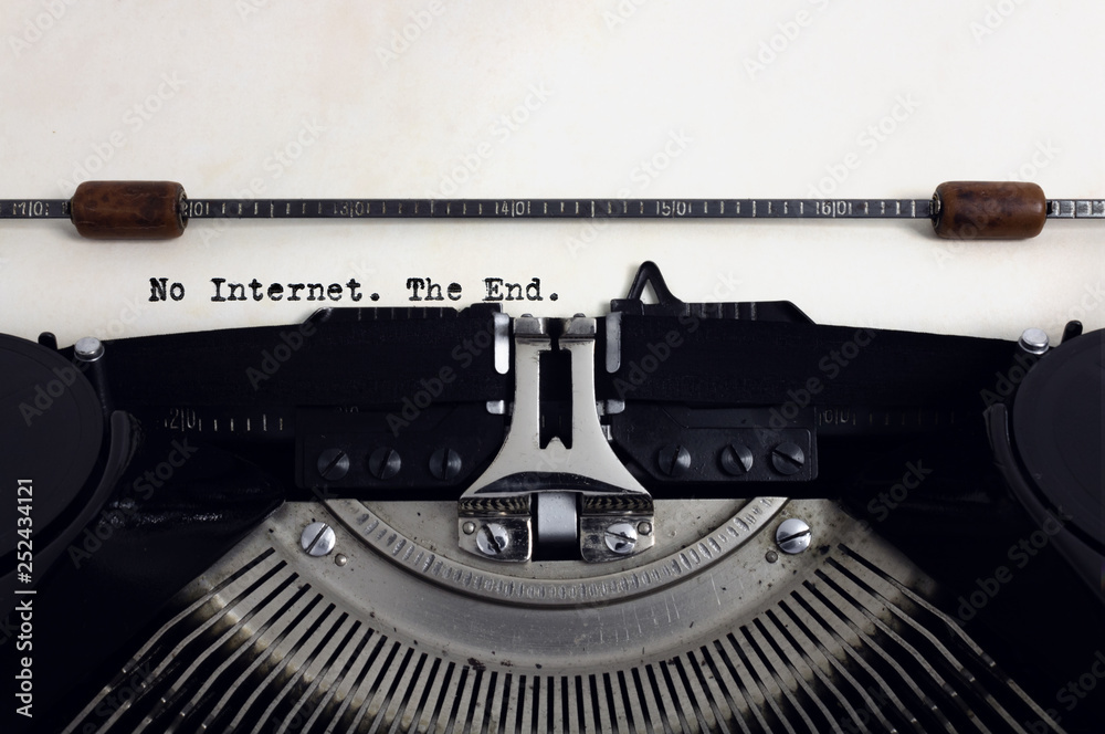 Fototapete old retro vintage black typewriter with close-up typing text no internet the end as heading on aged 