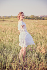 Beautiful young woman is saying goodbye and leaving. Portrait in meadow