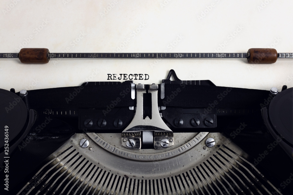Fototapete old retro vintage black typewriter with close-up typing text rejected as heading on aged paper
