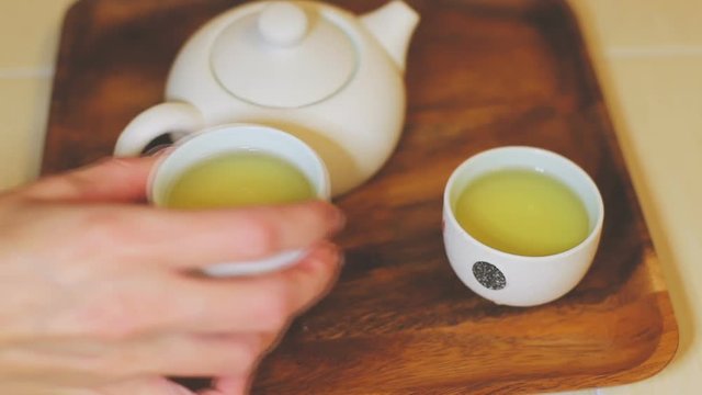 Traditional Chinese tea ceremony, green tea in a small teapot and white cups