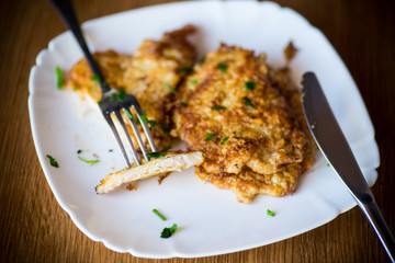 pork fillet chop fried in batter, in a plate
