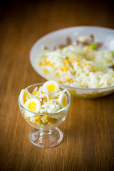 Fresh Peking cabbage salad with boiled eggs, canned corn