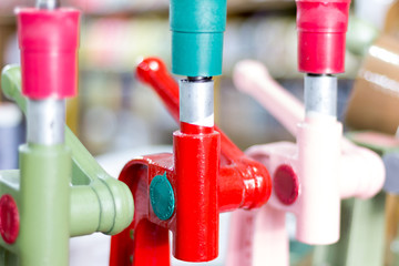 Detail of manual hand press buton machines with blurred background. Saara, Rio de Janeiro, Brazil. 2019