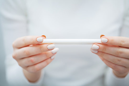 Woman Holding Pregnancy Test with positive results