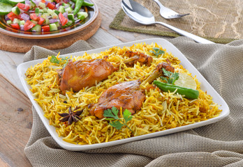 Chicken Biryani, a yummy & fluffy rice dish with spicy savory chicken pieces with salad.