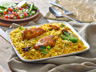 Chicken Biryani, a yummy & fluffy rice dish with spicy savory chicken pieces with salad.