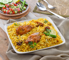 Chicken Biryani, a yummy & fluffy rice dish with spicy savory chicken pieces with salad.