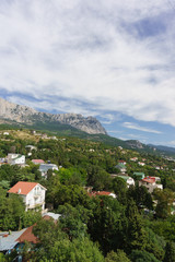 Fototapeta na wymiar Beautiful view of Alupka village and the top of AI-Petri mountain. Yalta, Crimea
