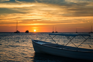 Boats anchored during a dramatic and beautiful sunset. Los Roques National Park 