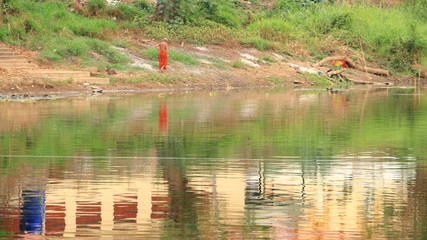 Monks are walking along the canal.