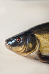 Coloring black lyn fish on a light board. Cooking food in a restaurant with fresh meat. Stock background, photo