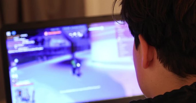 Teen playing on laptop computer at home 2