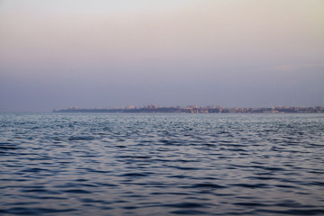 Evening sea on the background of the city. Beautiful landscape for design