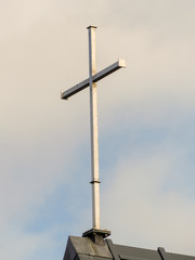 Steel cross on top of church roof