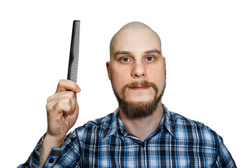 Bald funny emotional guy with a beard and with a comb in his hands, in the studio on isolated...