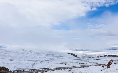 View of the snow covered mountains and the far end Namtso from the snowing Nagenla Mountain Pass,...