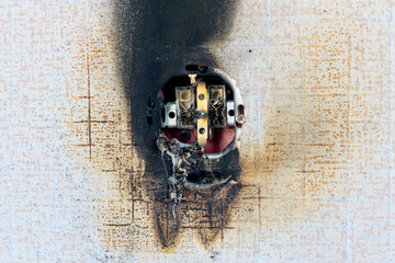 socket on fire. he is extinguished. plastic melted. bare wires.