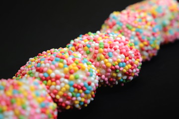 Dolci colorati di carnevale su sfondo nero, Colorful carnival sweets on a black background