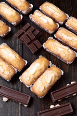 group of homemade sponge biscuits and pieces of chocolate on dark classic wood