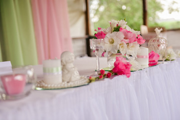 simple wedding table setting with a plate, spoon, fork and a sprig of lilac with a sign for the guest's name, table setting