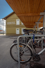 Fototapeta na wymiar Closeup of rental bikes parked near hostel on city street