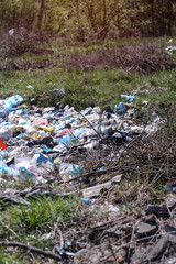 Environmental pollution. Rubbish in the green grass on nature. Ruined landscape. Stock background, photo