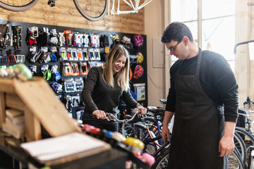 Young woman in bicycle shop.