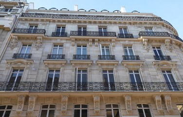 Traditional French house with typical balconies and windows. Paris.