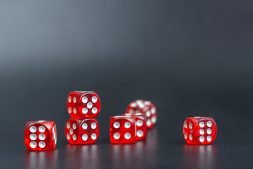 Rolling Play diced game. Group red dice on black background
