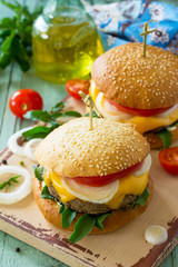 Arabic cuisine, Ramadan food. Delicious fresh Big sandwich - hamburger burger with vegetarian mung cutlets burger on a wooden kitchen table.