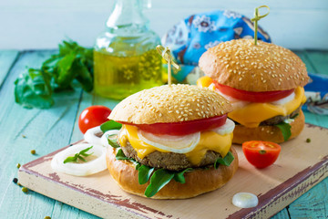 Arabic cuisine, Ramadan food. Delicious fresh Big sandwich - hamburger burger with vegetarian mung cutlets burger on a wooden kitchen table.