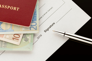 Signature, signing a document. Passport with euro banknotes. Topics of car rental, car sharing,...