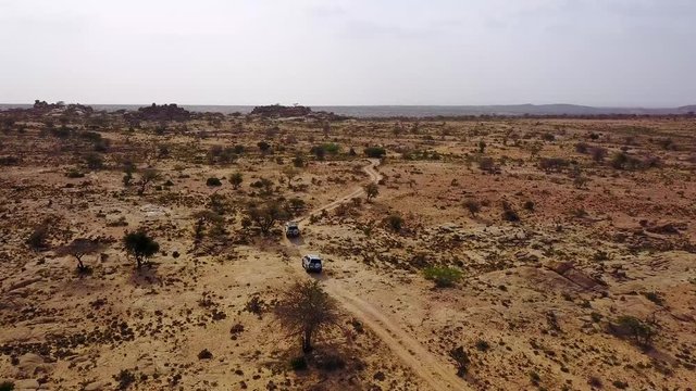 Good aerial of 4WD safari jeeps moving across Somalia near Hargeisa, Somaliland.
