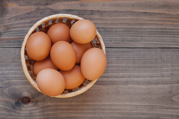 eggs in a basket on wooden table