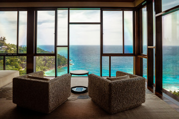 luxury beach chairs looking out over ocean of Praslin Seychelles