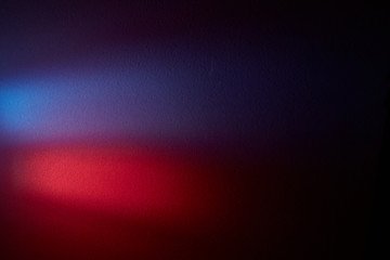 On a dark gradient background the volume blurry glow of red and violet color