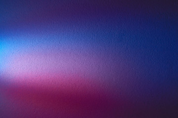 Blurred blue textured background with patches of pink and cream