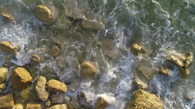 Waves Of Blue Ocean washing the Sand and Beach, aerial top view