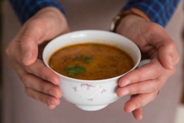 the Tarhana soup in the bowl that the woman hold it for kitchen and food concept. 