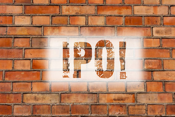 Fototapeta na wymiar Writing note showing Ipo. Business photo showcasing Initial Public Offering First time stock of company is offered to public Brick Wall art like Graffiti motivational call written on the wall