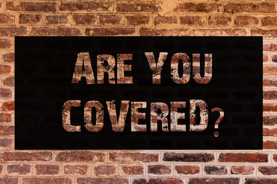 Text sign showing Are You Coveredquestion. Conceptual photo asking about you insurance health statement Brick Wall art like Graffiti motivational call written on the wall