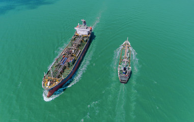 Aerial view Oil ship tanker move opposite directions for transportation from refinery on the sea.