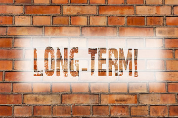 Writing note showing Long Term. Business photo showcasing Occurring over large period of time Future plans Brick Wall art like Graffiti motivational call written on the wall