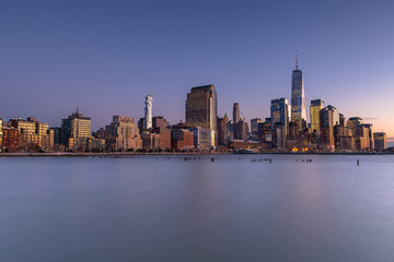 Fototapeta na wymiar Financial District from Hudson river at twilight with long exposure