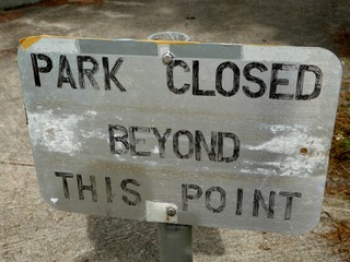 Close up of a “Park Closed” sign at the American Memorial Park after Typhoon Soudelor hit and uprooted all the trees in the park in 2015. 