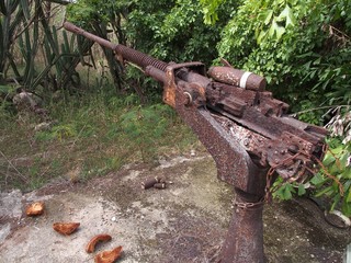 Ruins of an old Japanese cannon by the side of the road near Ladder Beach, southern part of Saipan, Northern Mariana Islands.