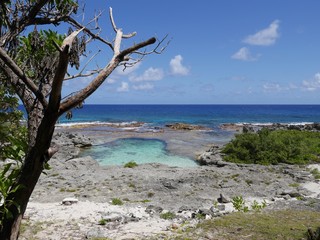 Wide shot of the scenic coastline with the popular swimming hole on Rota, an island in the Northern Mariana Islands.