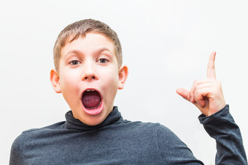 teen boy shows gesture by finger