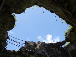 Wide gaping hole in the roof from the bombs at the ruins of the Japanese Air Command building at the Tinian Northfield, Northern Mariana Islands 